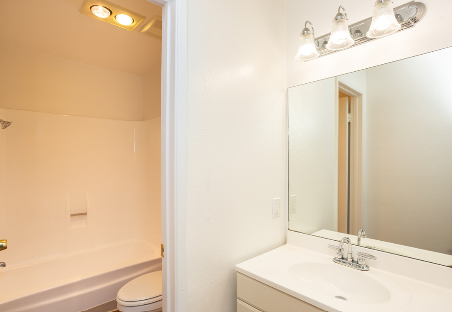 Windward Village Apartments bathroom vanity, toilet, and shower Windward Village Apartments bathroom vanity, toilet, and shower